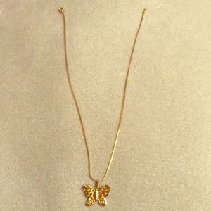 Golden butterfly necklace from 18KT Gold Shield.